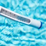 Swimming Pool Thermometer half out of the water