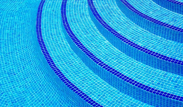 Light blue tiled pool steps with dark blue tiled edges