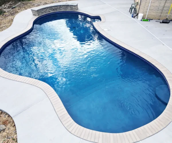 Inground pool in a custom shape.